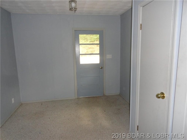 doorway to outside featuring light colored carpet