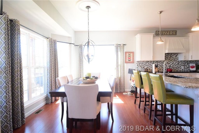 dining area featuring dark hardwood / wood-style floors and sink