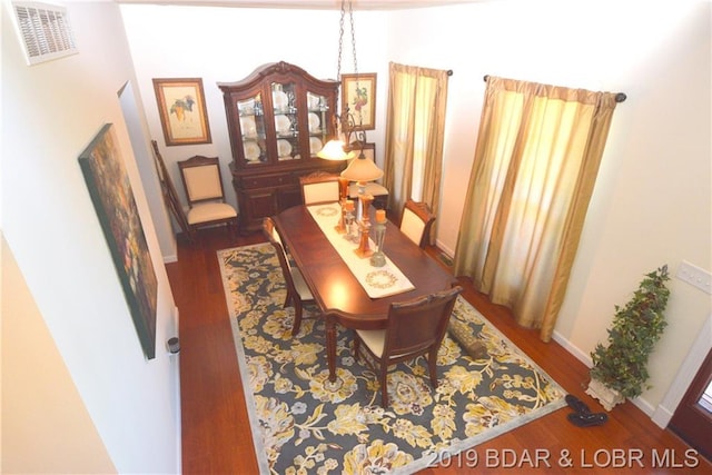 dining area featuring dark wood-type flooring