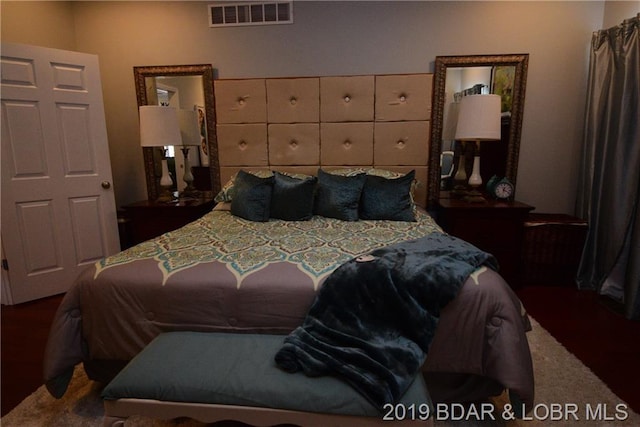 bedroom featuring dark colored carpet