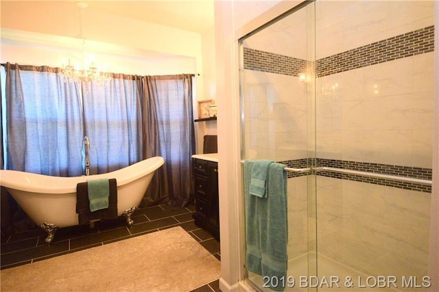 bathroom with a notable chandelier, vanity, tile flooring, and shower with separate bathtub