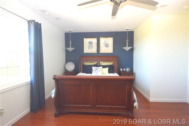 bedroom featuring ceiling fan and dark wood-type flooring