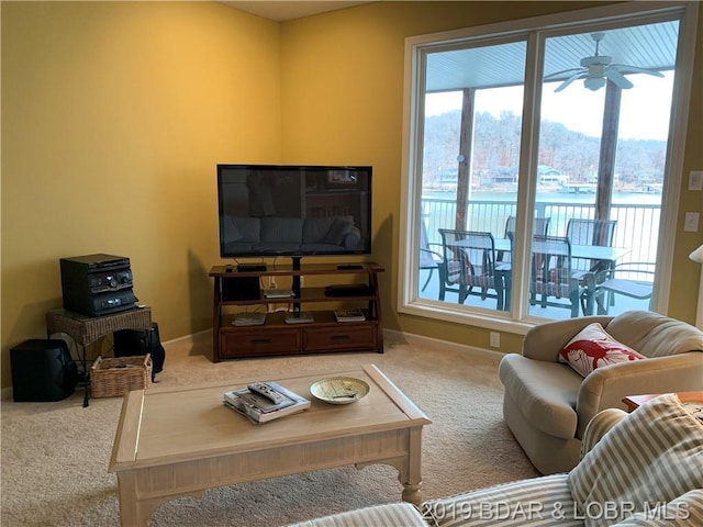 carpeted living room featuring ceiling fan