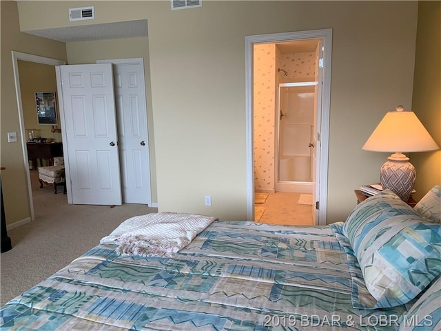 carpeted bedroom featuring connected bathroom