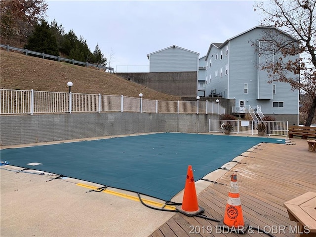 view of swimming pool with a wooden deck