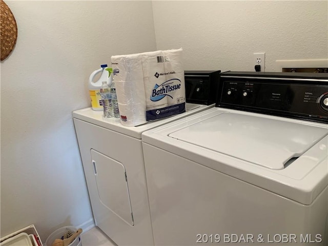 clothes washing area featuring independent washer and dryer