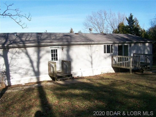 rear view of property featuring a yard