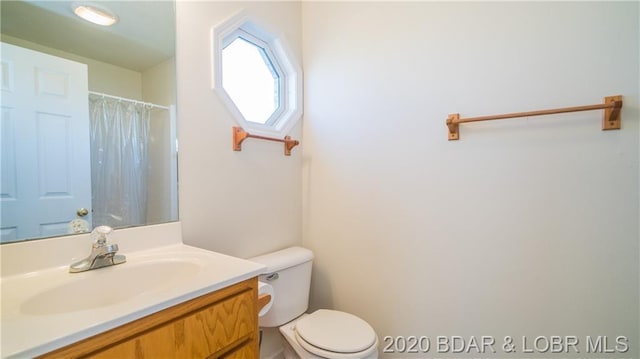 bathroom with toilet and vanity