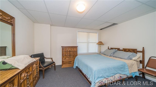 carpeted bedroom with a paneled ceiling