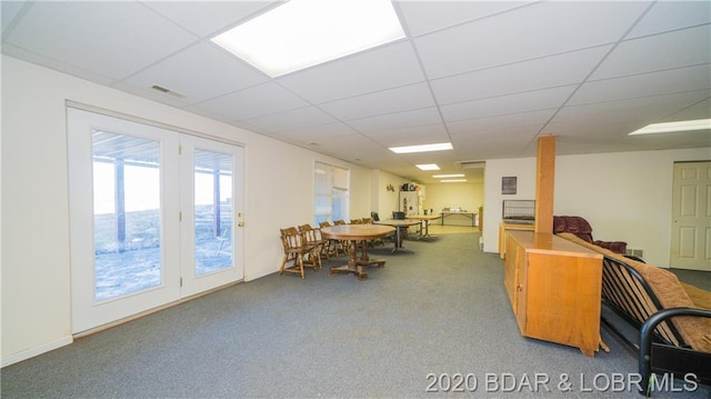 interior space with a drop ceiling and a healthy amount of sunlight