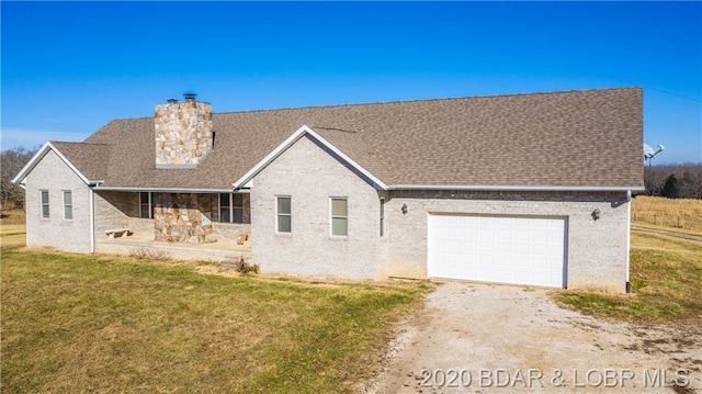 view of front of property with a front yard and a garage