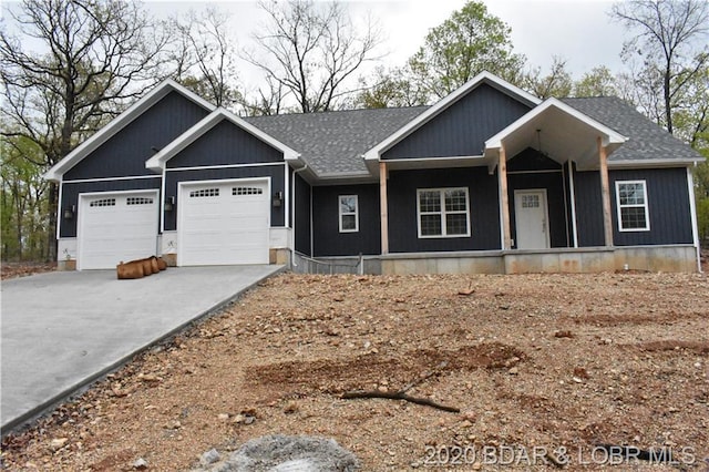 view of front of property featuring a porch and a garage