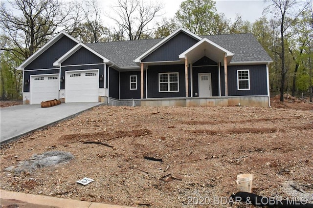 view of front of home with a porch and a garage