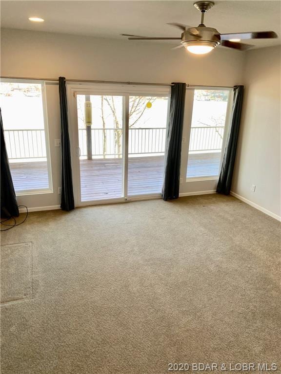 carpeted empty room with ceiling fan