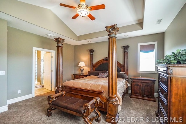 bedroom with ceiling fan, dark colored carpet, ensuite bathroom, and vaulted ceiling