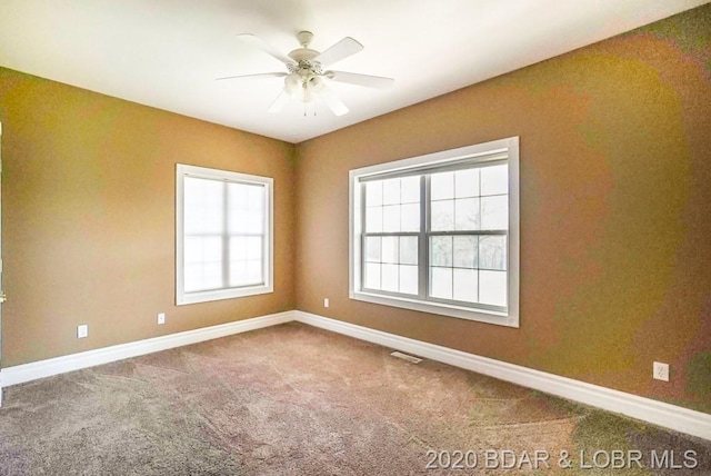 unfurnished room with ceiling fan and carpet floors