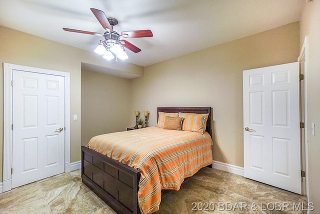 tiled bedroom with ceiling fan