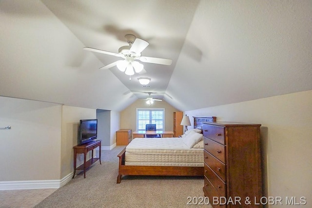 bedroom featuring light carpet, ceiling fan, and vaulted ceiling