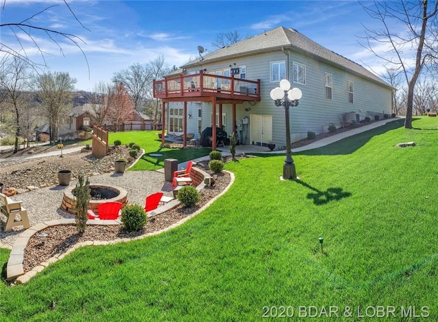 back of house with a lawn and a patio area