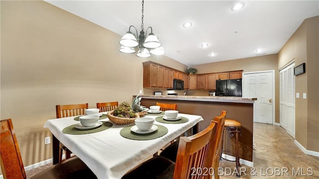 dining room featuring a chandelier and light tile flooring