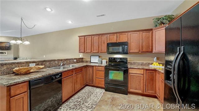 kitchen featuring sink, light tile floors, light stone counters, black appliances, and a notable chandelier