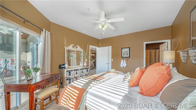 bedroom featuring ceiling fan and light carpet