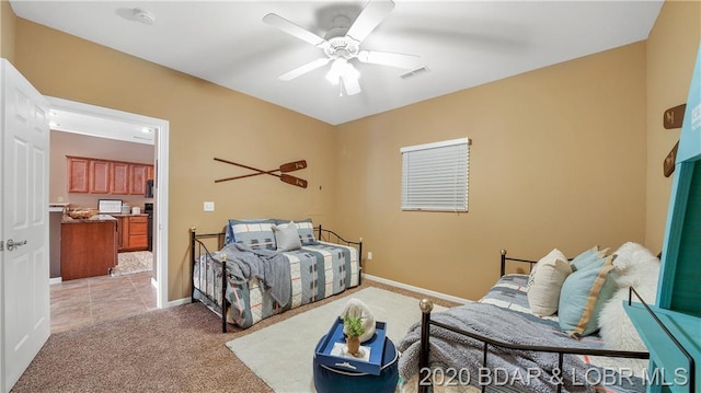 bedroom with ceiling fan and light colored carpet