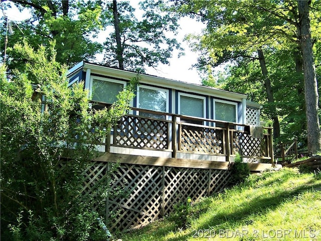 back of house with a wooden deck