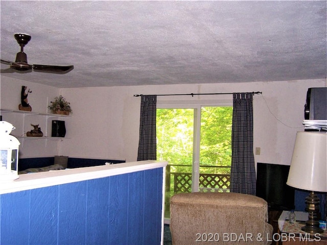 kitchen with a textured ceiling and ceiling fan