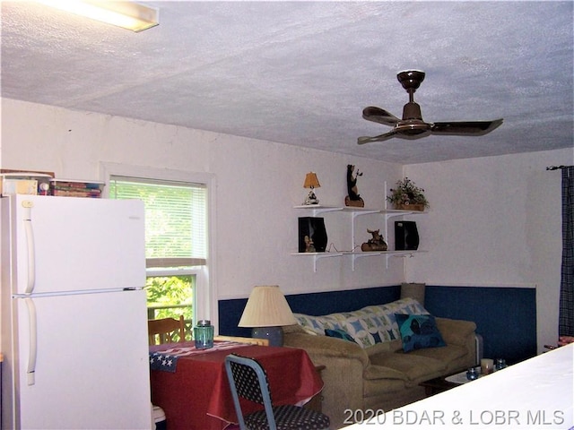 interior space featuring a textured ceiling and ceiling fan