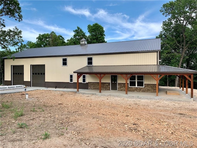 rear view of house featuring a garage