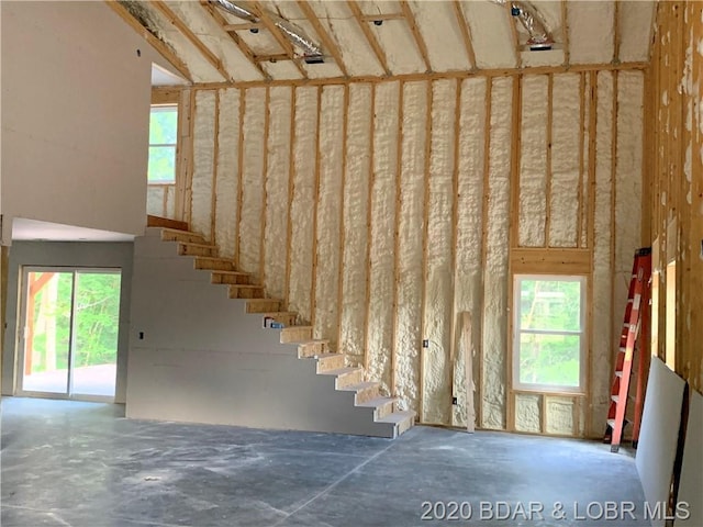 stairway featuring concrete flooring