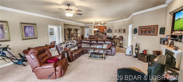 living room featuring light carpet, crown molding, and ceiling fan with notable chandelier