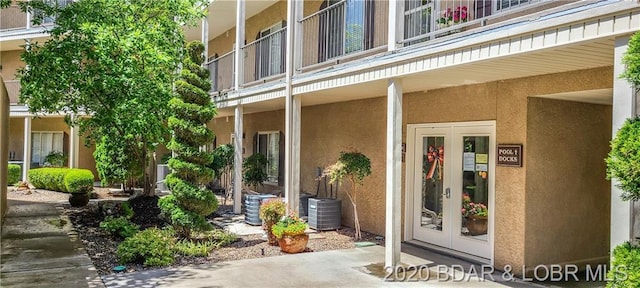 entrance to property with central air condition unit and french doors