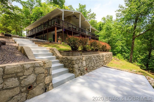 view of side of property featuring a wooden deck