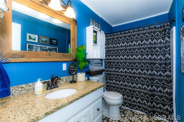 bathroom with tile flooring, a healthy amount of sunlight, vanity with extensive cabinet space, and toilet