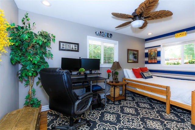 office space with ceiling fan and dark hardwood / wood-style flooring