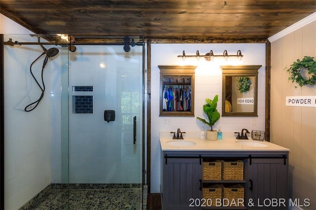 bathroom with double sink, large vanity, an enclosed shower, and wooden ceiling