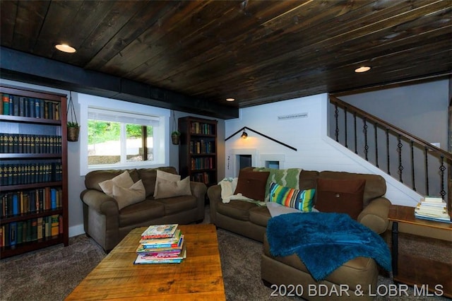 living room with dark colored carpet and wooden ceiling