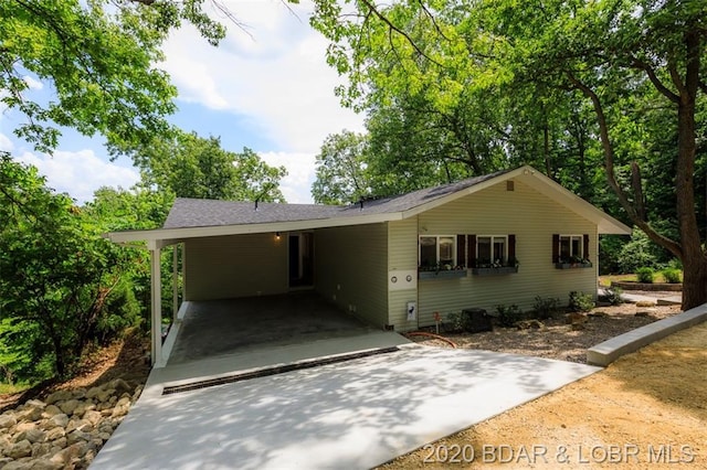 ranch-style home featuring a carport