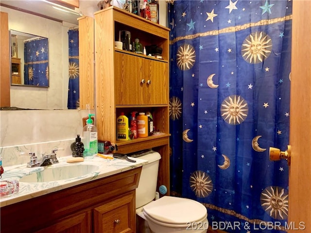 bathroom featuring toilet and vanity