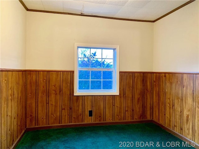 carpeted spare room with crown molding