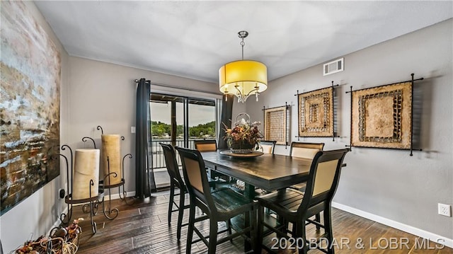 dining space featuring a chandelier and dark hardwood / wood-style flooring