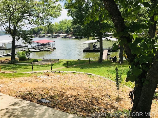 view of yard featuring a dock and a water view