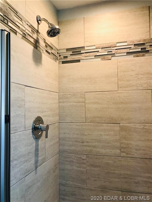 bathroom with tiled shower