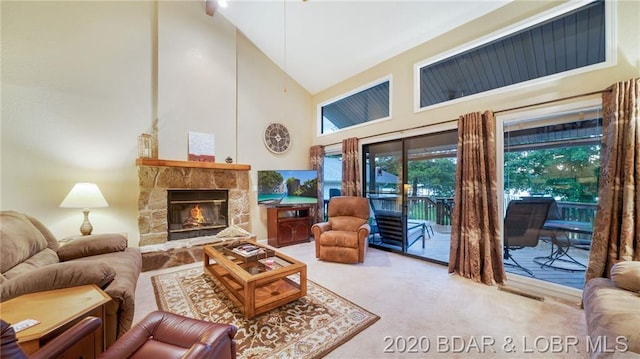 carpeted living room featuring high vaulted ceiling and a fireplace