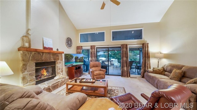 living room featuring light carpet, high vaulted ceiling, a fireplace, and ceiling fan