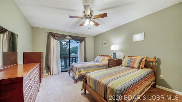 carpeted bedroom featuring ceiling fan, access to outside, and a textured ceiling