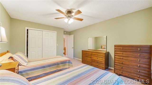 bedroom featuring ceiling fan, a closet, and light colored carpet