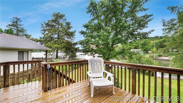 wooden terrace featuring a lawn